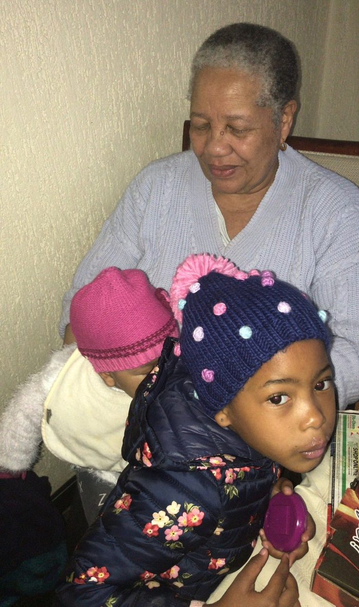 Gogo Margaret with grandchildren in woolly hats